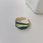 Golden titanium steel open-toed ring with a dual-layered, wavy design featuring green enamel detailing.