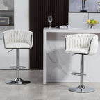 Set of two white, fabric-covered swivel bar stools with woven backrests and adjustable chrome pedestals with footrests.