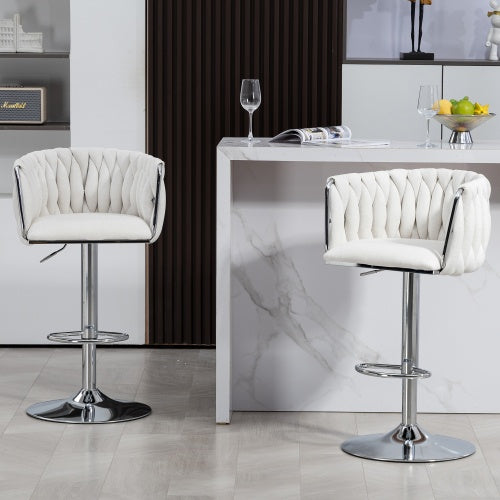 Set of two white, fabric-covered swivel bar stools with woven backrests and adjustable chrome pedestals with footrests.