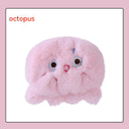 A fluffy, light pink plush octopus hand warmer with embroidered eyes and a small mouth. The word "octopus" is printed.