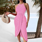Pink sleeveless halter dress in patterned crochet lace with an asymmetric, ruched wrap-style hemline.