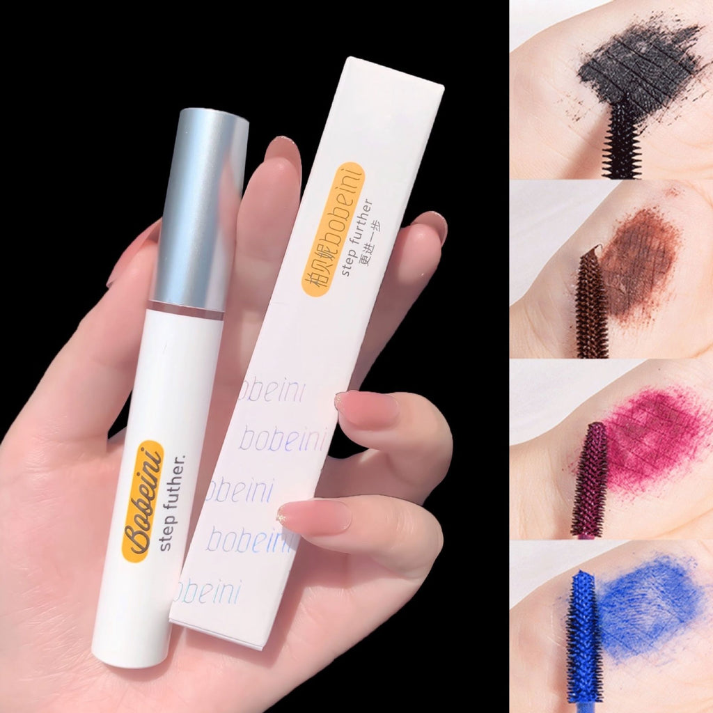 Hand holding a Bobeini mascara tube and box with swatches in black, brown, pink, and blue showing wand application.
