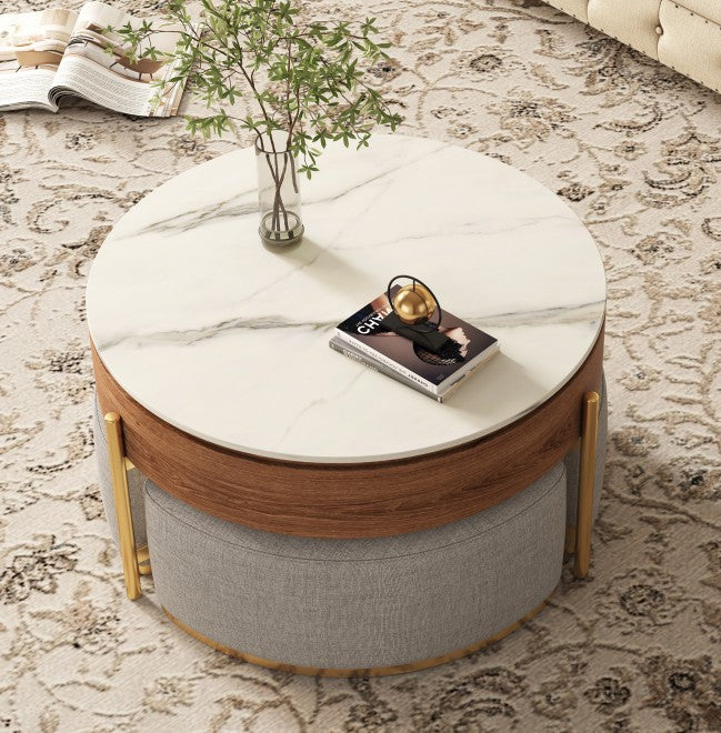 Round lift-top coffee table with marble-look top, wood frame, gold legs, and three gray fabric nesting stools underneath.