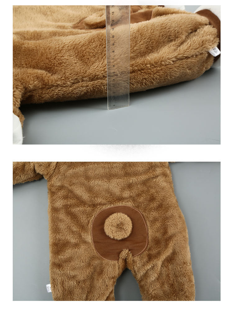 Soft, brown plush baby onesie featuring a round tail detail. Includes a ruler for size reference.