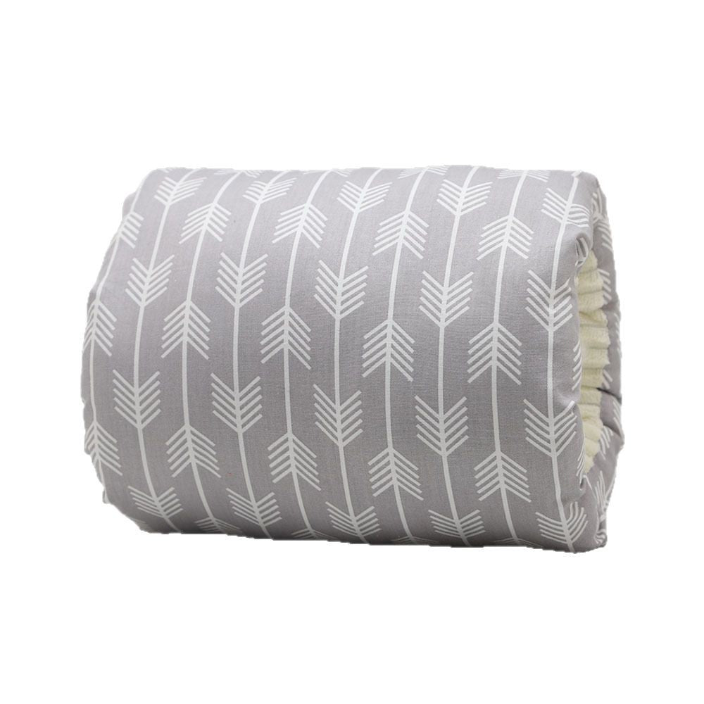 Grey cotton baby nursing arm pillow with a white arrow pattern and soft cream-colored lining.