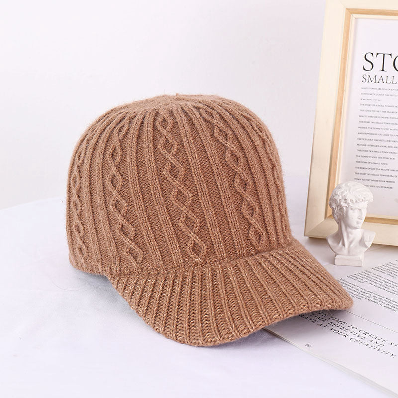Tan knitted wool baseball cap with cable knit texture and ribbed brim, providing a warm, Korean-style casual look.