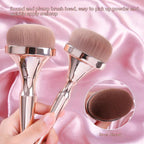 Two gold-handled makeup brushes with dense, round beige heads on a pink satin background. Includes an inset detail view.