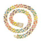 Gold Cuban chain with multicolored enamel bars and sparkling pave crystals on a white background.