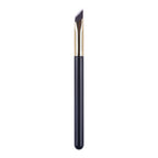 An angled eyebrow brush with dark bristles, a gold metal ferrule, and a sleek black handle against a white background.
