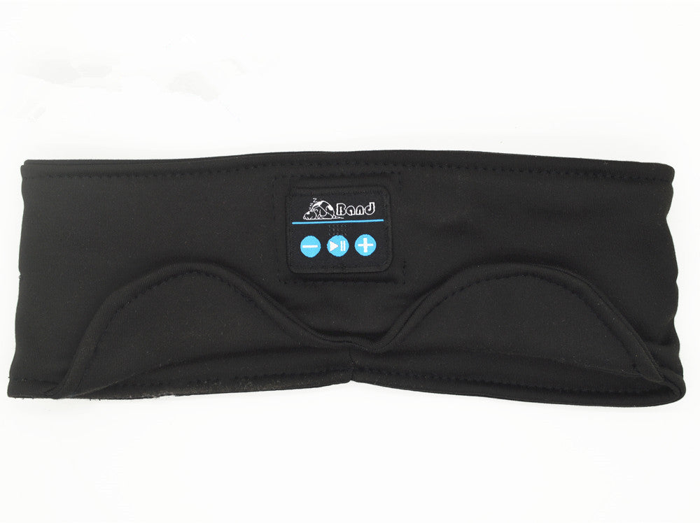 Black fabric Bluetooth sleep headband with integrated control panel, music playback buttons, and eye mask contour.