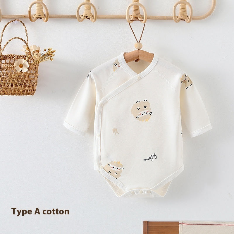 Cream-colored cotton baby bodysuit with sheep print, long sleeves, and snap-button wrap closure hanging on a hanger.