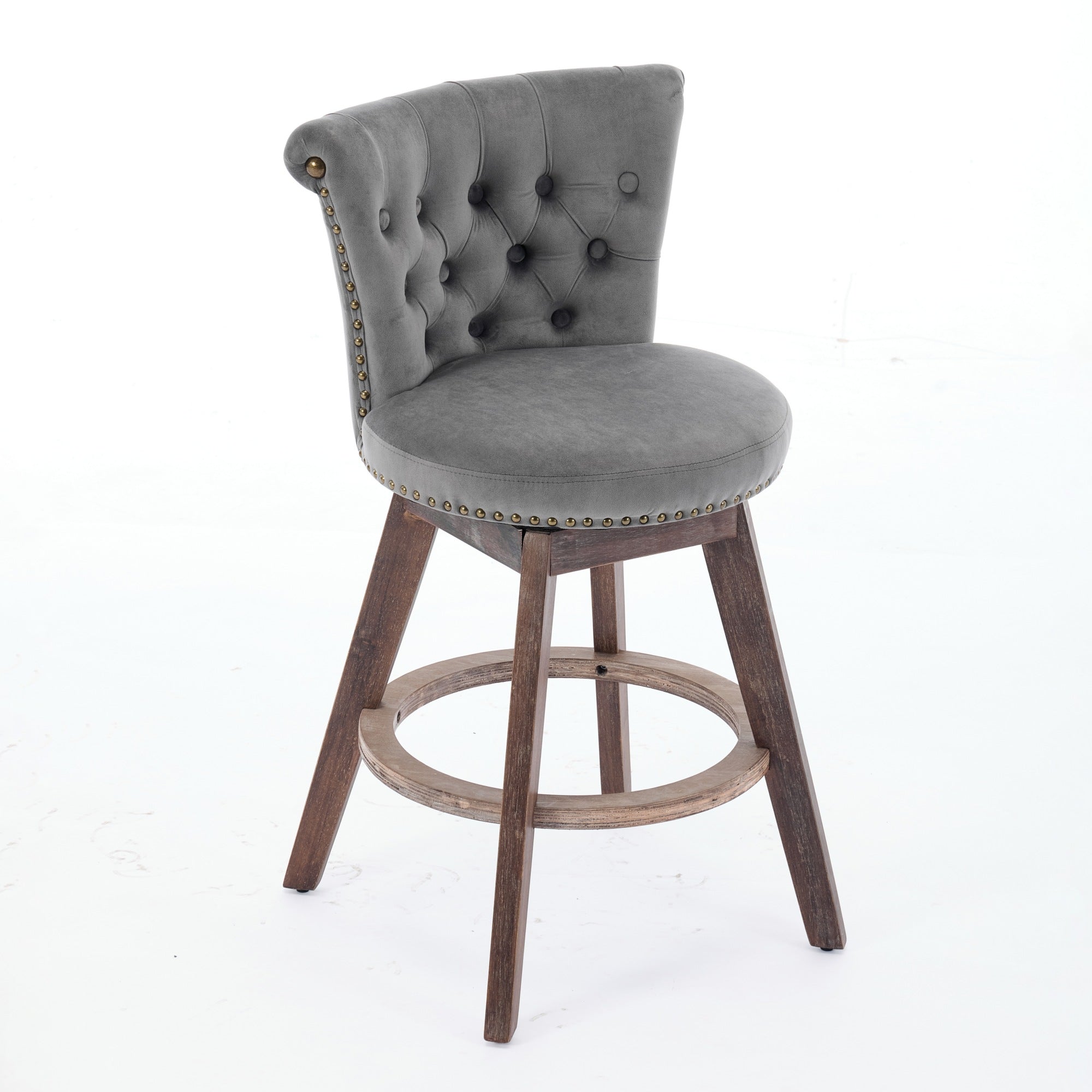 Gray velvet swivel bar stool with tufted back, nailhead trim, and dark wood legs with a round footrest.