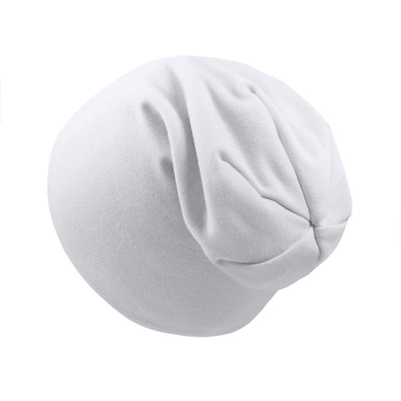 Plain white soft jersey newborn beanie cap with a gathered, slouchy design against a white background.