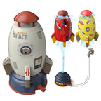 Multi-colored plastic rocket sprinkler toys for kids. Includes base, hose attachment, and water-powered floating rockets.