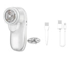 White portable lint remover with metal shaving head, cleaning brush, and USB charging cable on a white background.