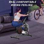 Woman in a white top and blue leggings rides a black stationary bike in a living room. Text reads "Real comfortable."