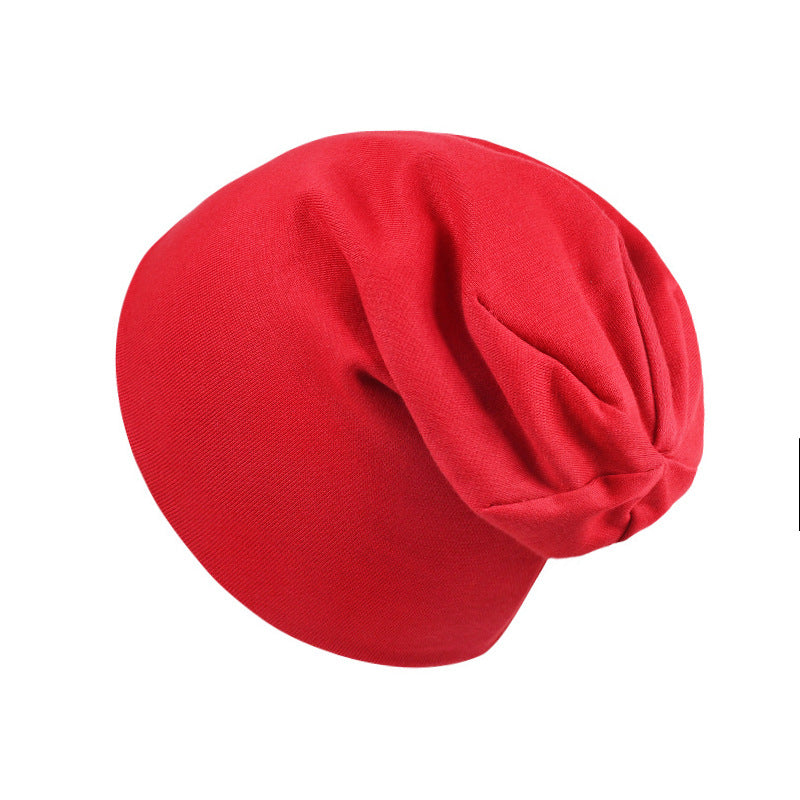 Bright red, soft jersey fabric newborn beanie with a slouchy, unstructured design on a clean white background.