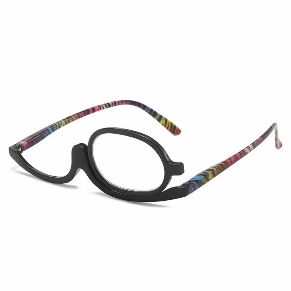 Digitaldistribution375 makeup reading glasses with a single, swiveling black frame and colorful patterned temples.