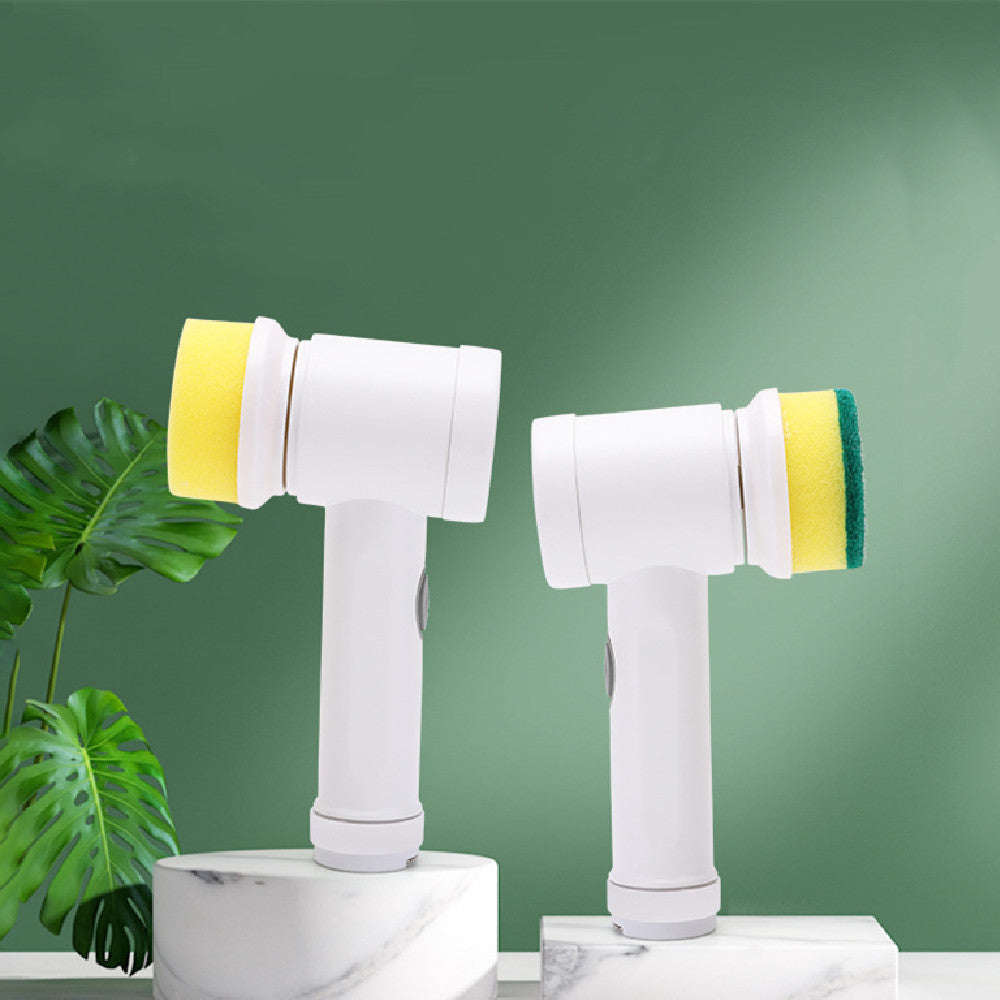Two white handheld electric cleaning brushes with yellow and green sponge heads on marble pedestals against green.