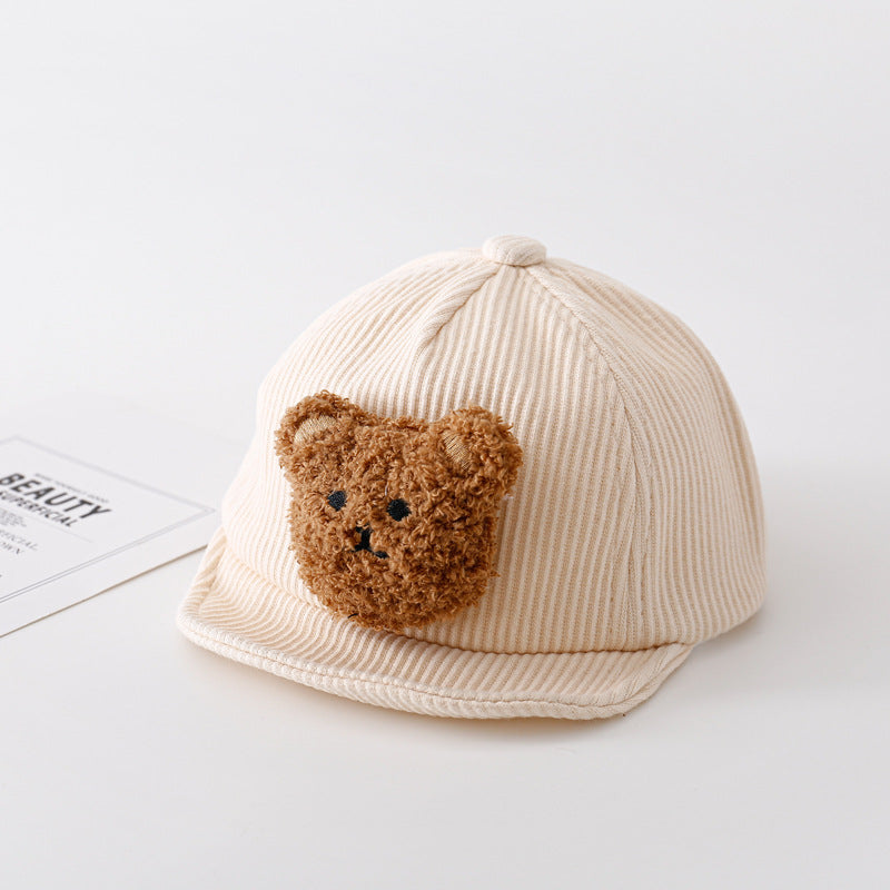 Beige ribbed corduroy baby baseball cap featuring a cute, fuzzy brown teddy bear patch on the front.