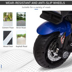 Close-up of a blue kids' electric motorcycle wheel with treaded, wear-resistant tires and simulated brake disc.
