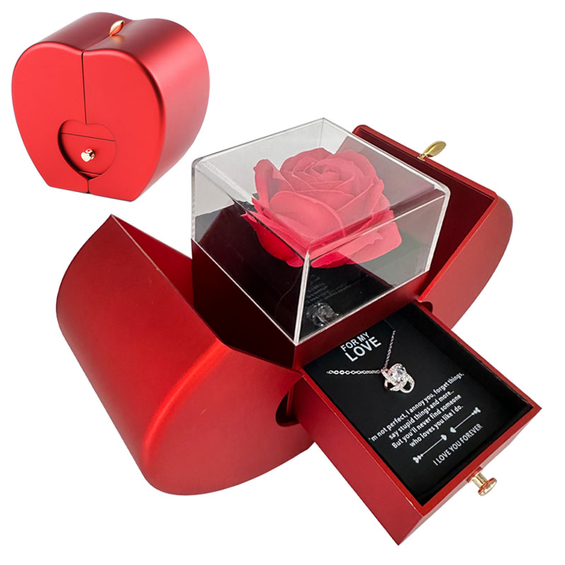 Red apple-shaped jewelry box with an artificial rose under glass and a drawer containing a necklace with a love note.