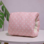 Pink cotton nursing arm pillow with white star pattern, featuring a soft, cushioned design for infant breastfeeding.