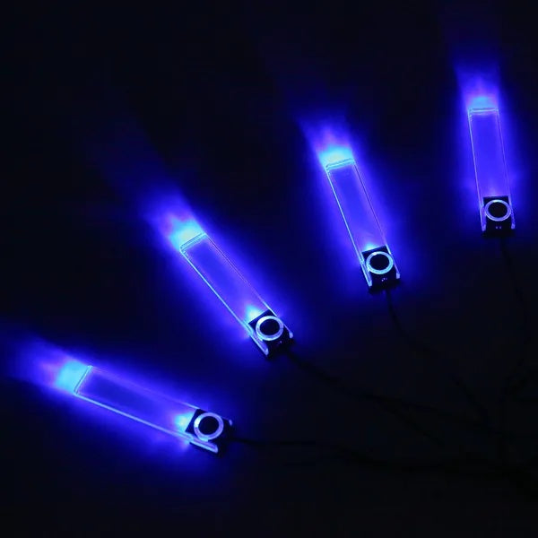 Four rectangular, translucent LED car interior light strips emitting a bright blue glow against a dark background.