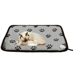 Gray pet heating pad with black paw prints and brown trim, featuring a cat and kitten resting on the surface.