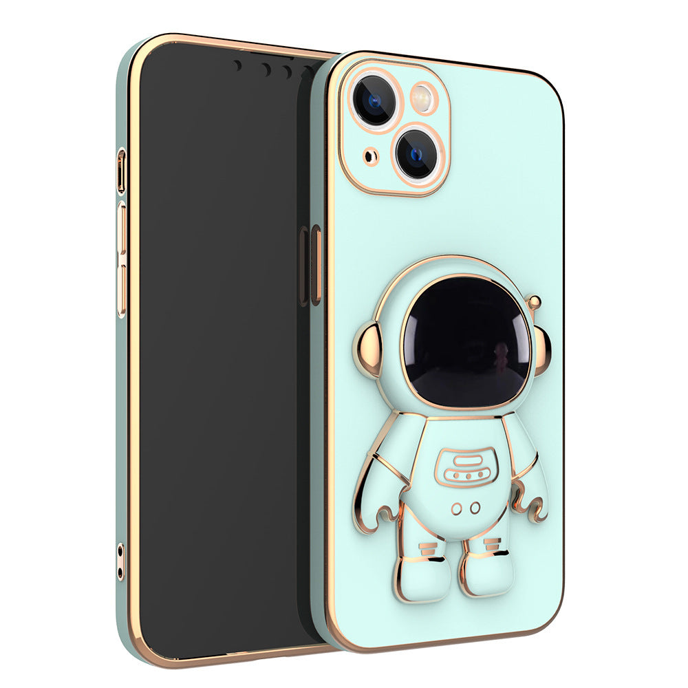 Mint green phone case with rose gold trim and a built-in 3D astronaut figure that serves as a kickstand.