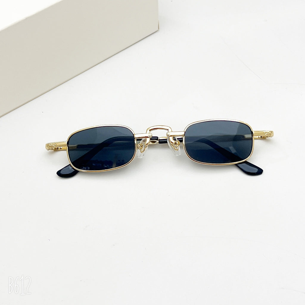 Retro hip-hop style rectangular sunglasses with a thin gold-tone metal frame and dark grey lenses on a white background.