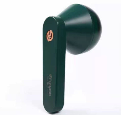 Dark green, USB-rechargeable handheld lint remover with a gold power button, sleek plastic design on white background.