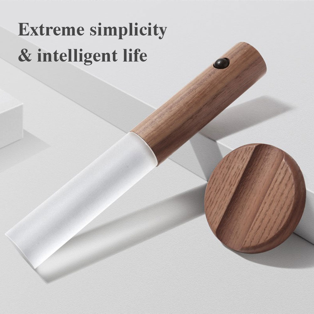 Magnetic wooden motion-sensor LED night light with frosted glass shade and circular mounting base on a gray background.