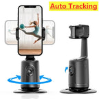 Black 360-degree auto-tracking phone gimbal with a round base, adjustable clip, and integrated camera for vlogging.