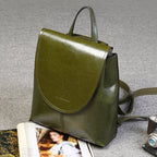 Olive green genuine leather retro-style women's backpack with a top handle, flap closure, and adjustable straps.