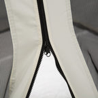 Close-up of black polyester gazebo mosquito netting featuring a sturdy center zipper and beige fabric trim.