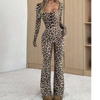 A woman wearing a slim-fit, long-sleeve leopard print jumpsuit with a square neckline and flared legs.