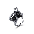 Silver-toned hip hop ring featuring a textured, thorny metal branch design framing a smooth, glossy black center stone.