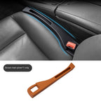 Brown plastic car seat gap organizer for the driver's side. Fits between the seat and console to hold small items.