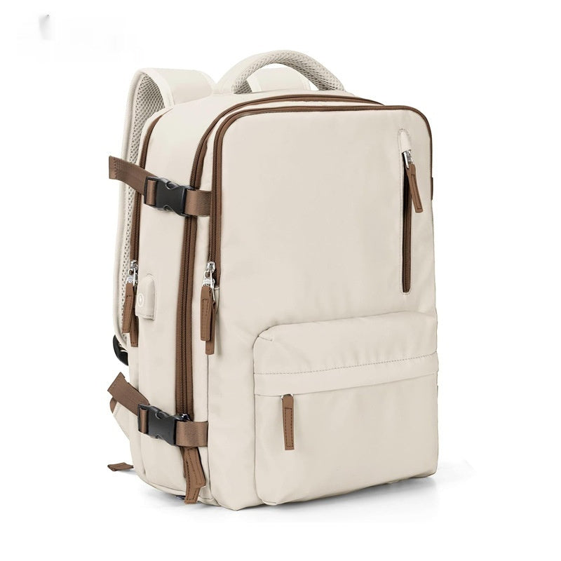Beige waterproof travel backpack with brown zippers, side buckled straps, multiple pockets, and padded shoulder straps.