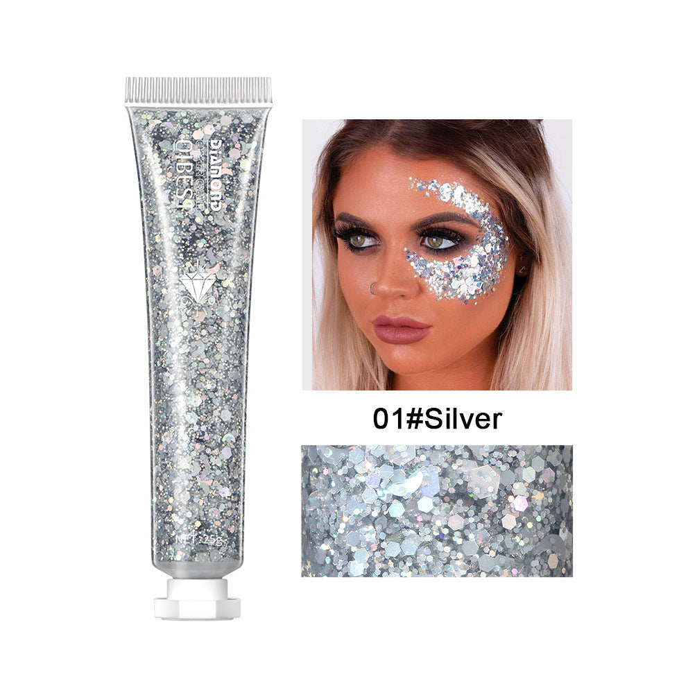Silver glitter gel tube with applicator shown on a model's face for stage makeup. Sparkly, reflective cosmetic cream.