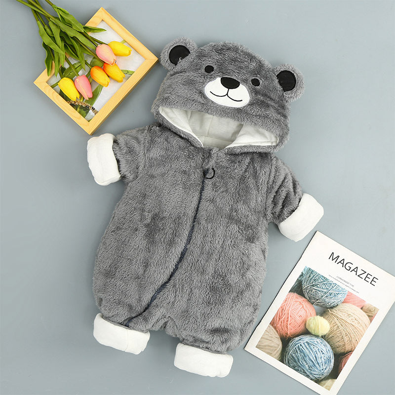 Gray plush baby onesie with bear-eared hood, white cuffs, and zipper closure, displayed on a flat surface.