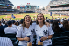 Two women friends wearing Yankees jerseys at the game