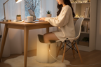 Woman working from home with feet on under-desk foot warmer